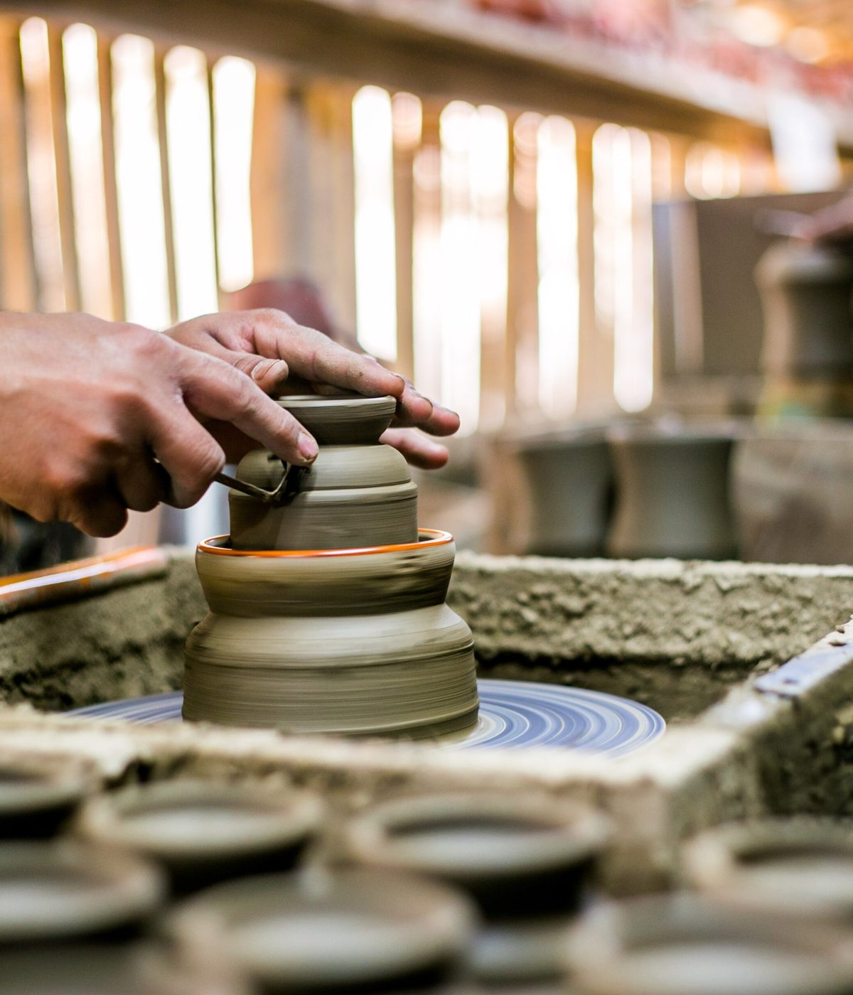 A potter shaping clay on the wheel